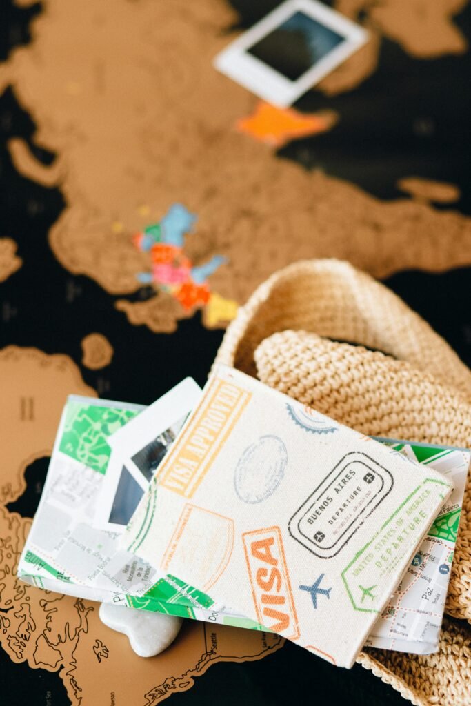 Travel essentials and accessories laid over a world map, highlighting wanderlust and adventure.